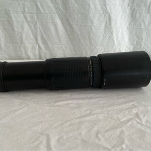 Tameron 200 to 400 telephoto lens, black with lens shield.